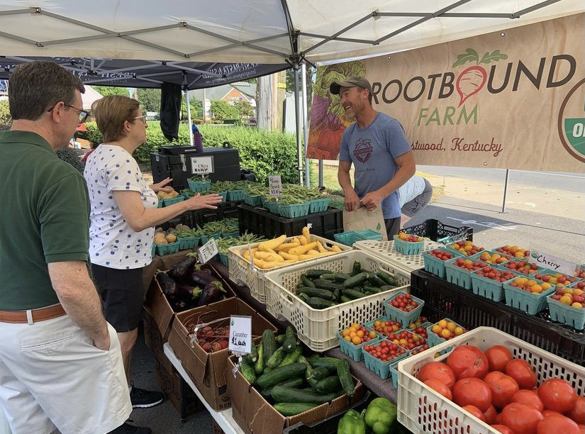 Rootbound's farmers market stand, complete with baskets of a variety of fresh vegetables.